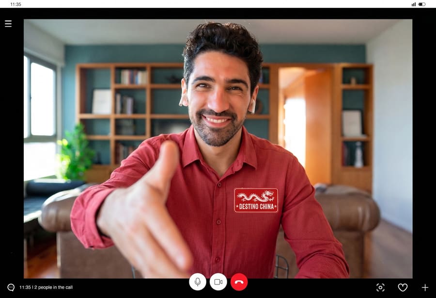 Asesor de viajes con vestimenta color rojo, haciendo un saludo